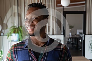 Head shot portrait of dreamy smiling African American businessman