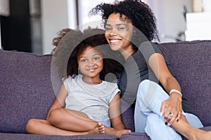 Head shot portrait happy African American mother with daughter