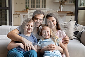 Head shot portrait happy family with two kids at home