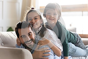 Head shot portrait happy father relaxing with adorable children