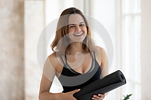 Head shot portrait happy smiling beautiful woman holding yoga mat