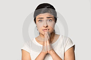 Head shot portrait Indian girl joining hands in praying gesture