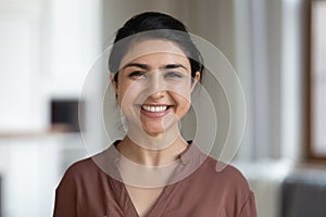 Head shot portrait Indian woman with healthy toothy smile