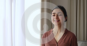 Head shot portrait Indian woman standing indoor breath fresh air