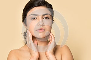 Head shot portrait Indian woman touching perfect smooth face skin