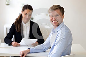 Head shot portrait of male applicant at successful job interview