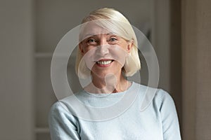 Head shot portrait mature woman with healthy toothy smile