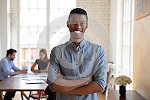 Head shot portrait of millennial skilled african american male manager.