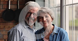 Head shot portrait older spouses smile look at camera