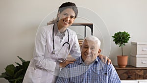 Head shot portrait of optimistic therapist and happy older patient