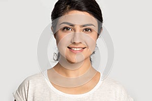 Head shot portrait pleasant attractive happy smiling indian young woman.