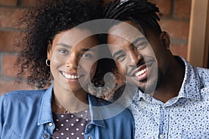 Head shot portrait smiling African American couple looking at camera