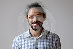 Head shot portrait smiling African American man on grey background