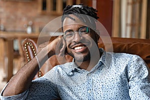 Head shot portrait smiling African American man wearing glasses