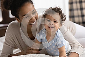 Head shot portrait smiling African American mother and toddler girl