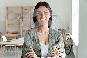 Head shot portrait smiling confident businesswoman with arms crossed