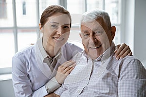 Head shot portrait smiling female doctor and older patient