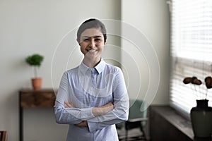 Head shot portrait smiling Indian woman with folded hands