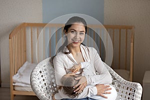 Head shot portrait smiling loving mother breastfeeding little daughter