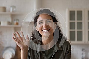 Head shot portrait smiling woman waving hand, making video call