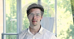 Head shot portrait successful businessman in glasses posing in office