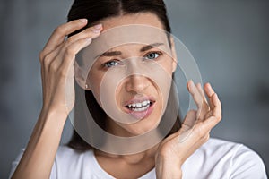 Head shot portrait unhappy woman worried about wrinkle or acne