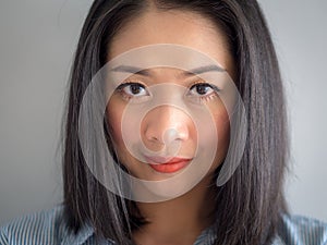 Head shot portrait of woman with big eyes.