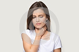 Head shot portrait woman touch neck feels pain in throat