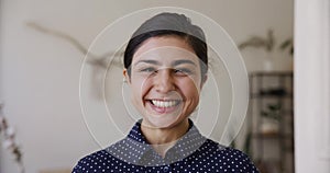 Head shot portrait young attractive Indian woman posing indoors