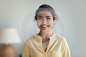 Head shot portrait young Indian woman posing at home