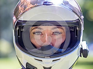 Head shot of pretty woman wearing motorcycle helmet