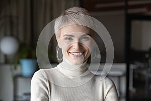 Head shot profile portrait blonde businesswoman in modern office.