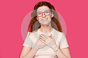 Head shot sincere smiling red-haired woman feeling thankful.