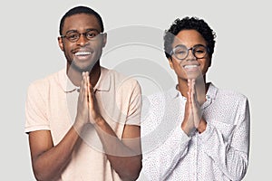 Head shot smiling African American couple holding hands in prayer