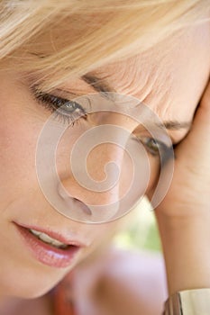 Head shot of woman scowling photo