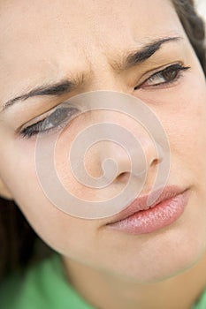 Head shot of woman scowling photo