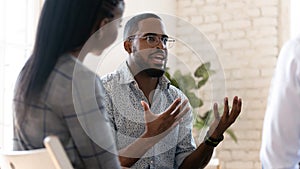 Head shot young african american male psychologist meeting patients.