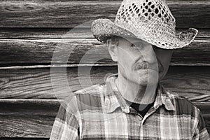 Head and shoulder portrait of a man in cowboy hat.