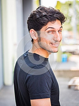 Head and shoulder shot of one handsome young man laughing