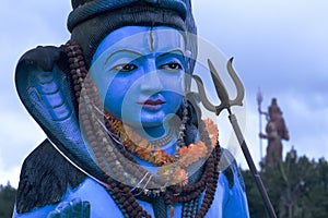 Head and shoulders of a colourful statue of the Hindu God,Shiva showing detail.