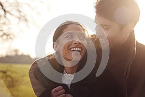 Head And Shoulders Of Loving Young Couple Walking Through Winter Countryside Together