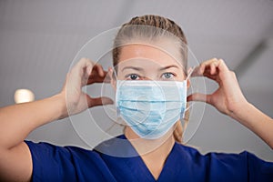 head and shoulders portrait female doctor wearing protective mask