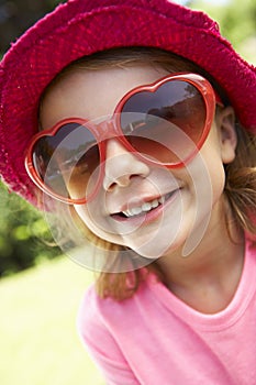 Head And Shoulders Portrait Of Girl Wearing Pink Straw Hat