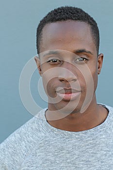 Head and shoulders portrait of a handsome African American man on a blue background