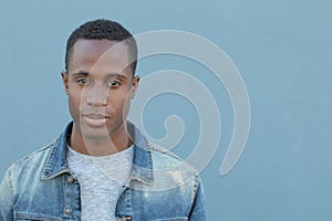 Head and shoulders portrait of a handsome African American man isolated on a blue background with copy space