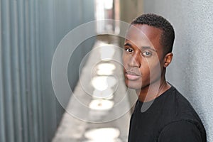 Head and shoulders portrait of a handsome African American man on urban background outdoors with copy space