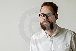 Head and shoulders portrait of handsome man with beautiful beard isolated on white background with copy space