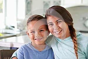 Head And Shoulders Portrait Of Hispanic Children At Home