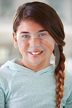 Head And Shoulders Portrait Of Hispanic Girl At Home