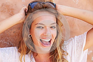 Head And Shoulders Portrait Of Pretty Woman Against Wall